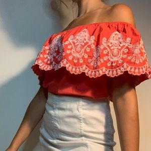 Salmon color with white pattern on top.